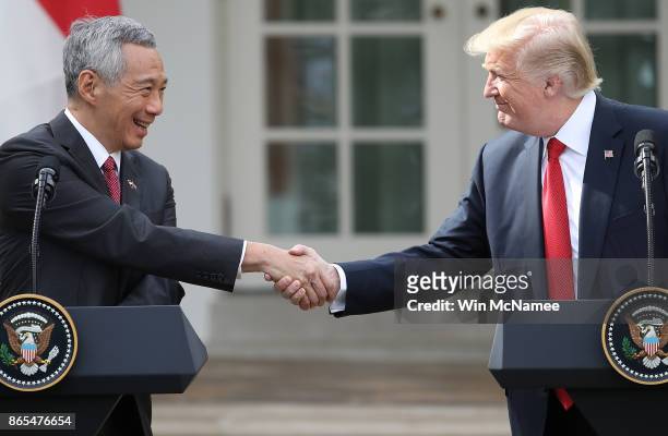 President Donald Trump and Singapore Prime Minister Lee Hsien Loong shake hands while delivering joint statements in the Rose Garden of the White...