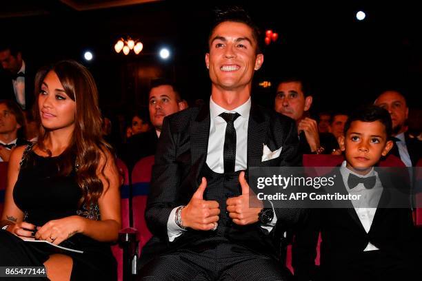 Nominee for the Best FIFA football player, Real Madrid and Portugal forward Cristiano Ronaldo , gestures next to his son Cristiano Ronaldo Jr and...
