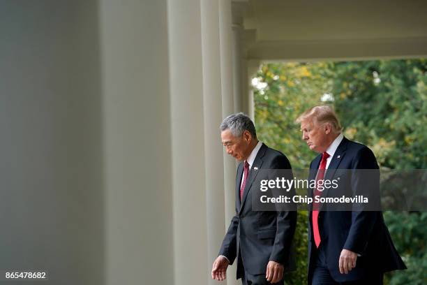 President Donald Trump and Singapore Prime Minister Lee Hsien Loong walk into the Rose Garden before delivering joint statements to the press at the...