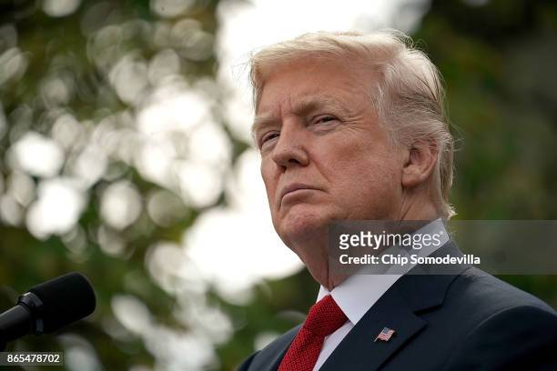 President Donald Trump listens to Singapore Prime Minister Lee Hsien Loong as they deliver joint statements in the Rose Garden of the White House...