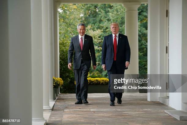 President Donald Trump and Singapore Prime Minister Lee Hsien Loong walk into the Rose Garden before delivering joint statements to the press at the...