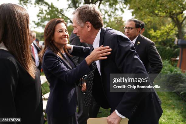 Trade Representative Robert Lighthizer embraces Deputy National Security Advisor Dina Powell after joint statements by President Donald Trump and...