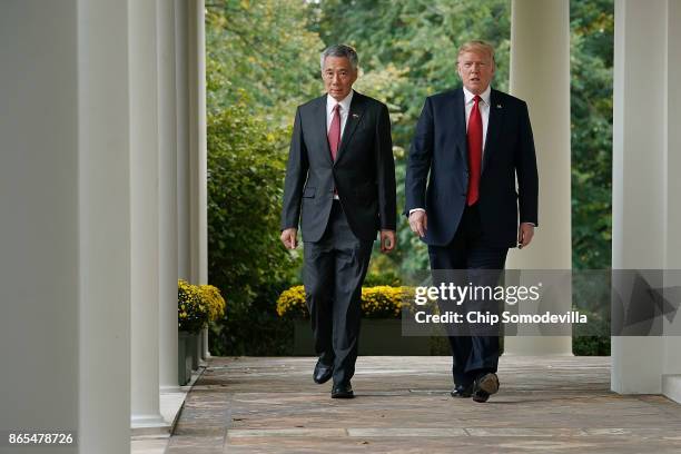 President Donald Trump and Singapore Prime Minister Lee Hsien Loong walk into the Rose Garden before delivering joint statements to the press at the...