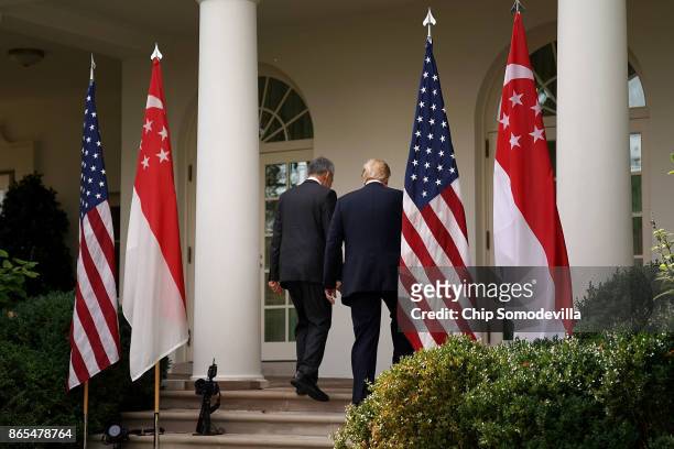 President Donald Trump and Singapore Prime Minister Lee Hsien Loong walk back into the White House after delivering joint statements to the news...
