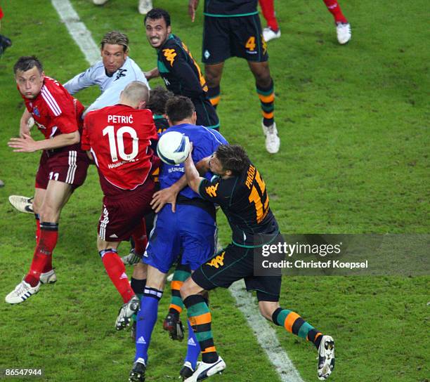 Frank Rost of Hamburg misses a big chance against Sebastian Proedl of Bremen during the UEFA Cup Semi Final second leg match between Hamburger SV and...