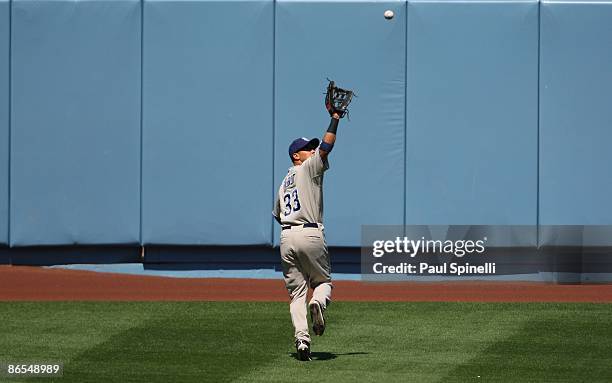 Center fielder Jody Gerut of the San Diego Padres runs back toward the warning track to catch a deep fly ball hit by Juan Pierre of the Dodgers for...