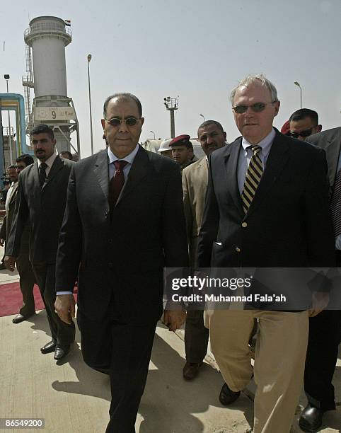 Ambassador to Iraq Christopher R. Hill walks with Iraqi Minister of Electricity Dr. Karim Wahid on a tour of the U.S.-funded Al-Qudas power plant...