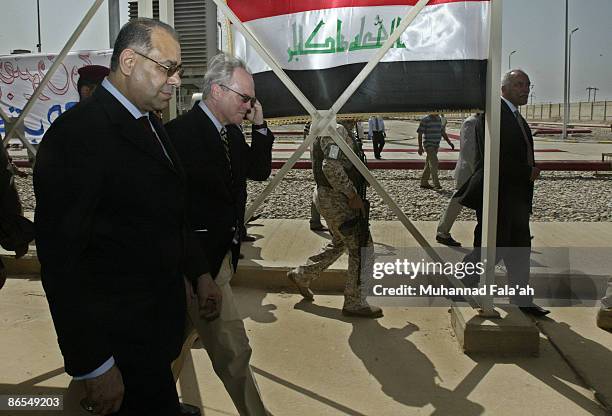 Ambassador to Iraq Christopher R. Hill walks with Iraqi Minister of Electricity Dr. Karim Wahid on a tour of the U.S.-funded Al-Qudas power plant...