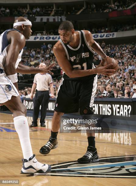 Tim Duncan of the San Antonio Spurs looks to move the ball against Erick Dampier of the Dallas Mavericks in Game Three of the Western Conference...