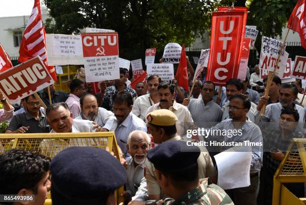 Members of All India Central Council of Trade Unions protest outside Nirman Bhawan against the Metro fare hike, on October 23, 2017 in New Delhi,...