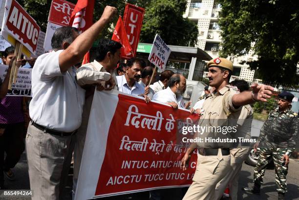 Members of All India Central Council of Trade Unions protest outside Nirman Bhawan against the Metro fare hike, on October 23, 2017 in New Delhi,...