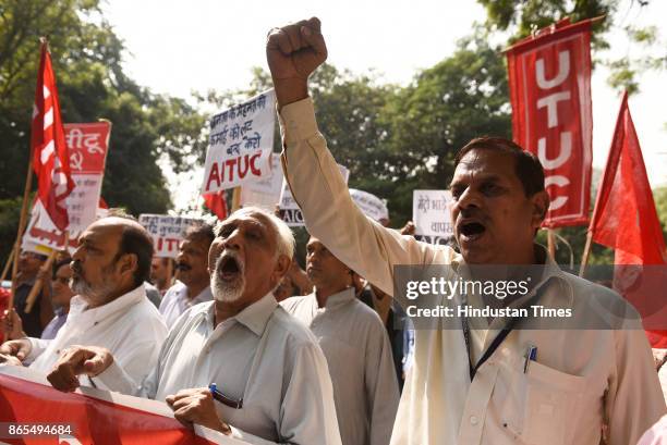 Members of All India Central Council of Trade Unions protest outside Nirman Bhawan against the Metro fare hike, on October 23, 2017 in New Delhi,...