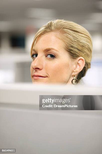woman in cubicle - peeking cubicle stock pictures, royalty-free photos & images