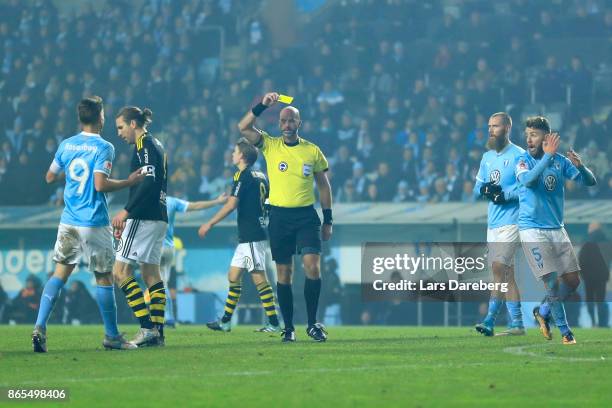 Referee Stefan Johanessen give Erdal Rakip of Malmo FF a yellow card during the allsvenskan match between Malmo FF and AIK at Swedbank Stadion on...