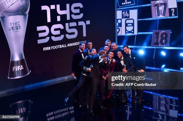 British actor Idris Elba, acting as host, poses for a selfie photograph with Real Madrid and Portugal forward Cristiano Ronaldo, Barcelona and...