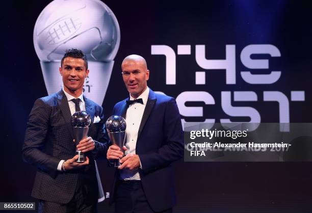 Cristiano Ronaldo and Zinedine Zidane pose for a photo accepts The Best FIFA Men's Player award during The Best FIFA Football Awards at The London...