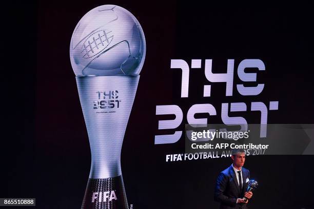 Real Madrid and Portugal forward Cristiano Ronaldo stands with the trophy after winning The Best FIFA Men's Player of 2017 Award during The Best FIFA...