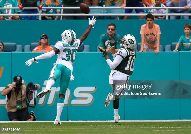New York Jets wide receiver Jermaine Kearse catches a touchdown pass guarded by Miami Dolphins cornerback Cordrea Tankersley during an NFL football...