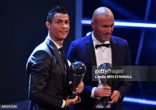 Real Madrid's French coach Zinedine Zidane stands with his trophy for winning The Best FIFA Men's Coach of 2017 Award alongside Real Madrid and...