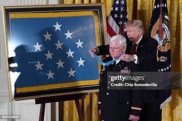 President Donald Trump awards retired U.S. Army Capt. Gary Rose with the Medal of Honor during a ceremony in the East Room of the White House October...