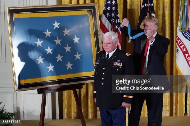 President Donald Trump awards retired U.S. Army Capt. Gary Rose with the Medal of Honor during a ceremony in the East Room of the White House October...