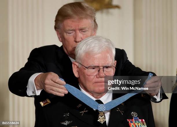 President Donald Trump awards retired U.S. Army Capt. Gary Rose, of Huntsville, Alabama, with the Medal of Honor during a ceremony in the East Room...