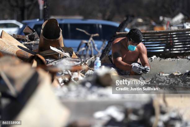 Ben Hernandez sifts through the remains of his Coffey Park home that was destroyed by the Tubbs Fire on October 23, 2017 in Santa Rosa, California....