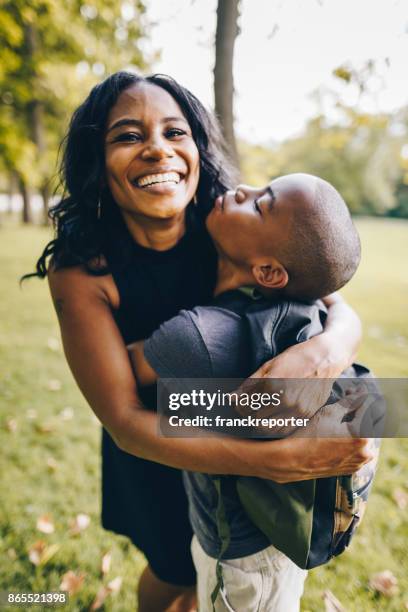 mother and son embracing in the park - single mother teen stock pictures, royalty-free photos & images