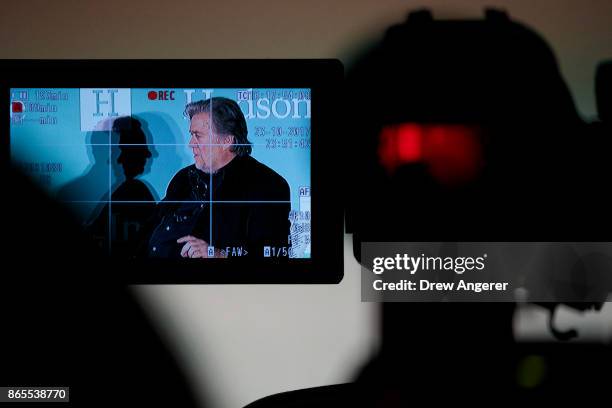 Displayed on a video camera monitor, Steve Bannon, former White House chief strategist and chairman of Breitbart News, speaks during a discussion on...