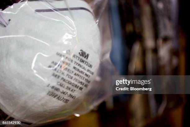 The 3M Co. Logo is seen on a dust mask in this arranged photograph taken in Tiskilwa, Illinois, U.S., on Monday, Oct. 23, 2017. 3M is scheduled to...