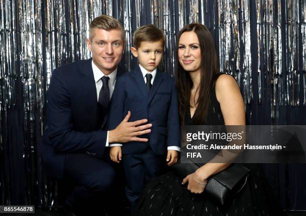 Toni Kroos, his son Leon and his wife Jessica Farber are pictured inside the photo booth prior to The Best FIFA Football Awards at The London...