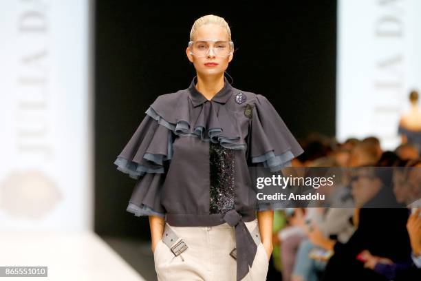 Model presents a creation by Russian designer Julia Dalakian during the Mercedes-Benz Fashion Week in Moscow, Russia on October 23, 2017.