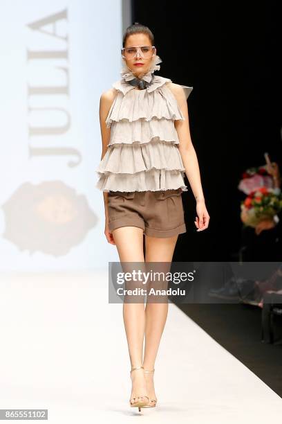 Model presents a creation by Russian designer Julia Dalakian during the Mercedes-Benz Fashion Week in Moscow, Russia on October 23, 2017.