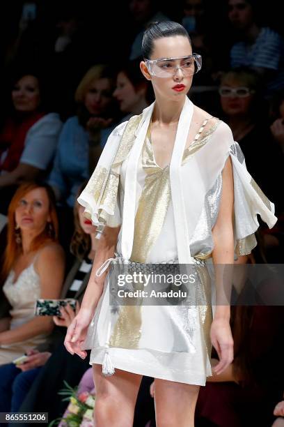 Model presents a creation by Russian designer Julia Dalakian during the Mercedes-Benz Fashion Week in Moscow, Russia on October 23, 2017.