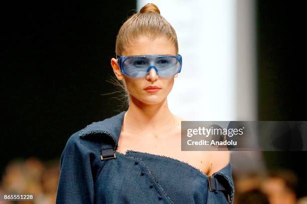 Model presents a creation by Russian designer Julia Dalakian during the Mercedes-Benz Fashion Week in Moscow, Russia on October 23, 2017.