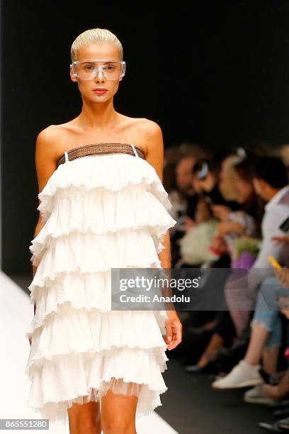 Model presents a creation by Russian designer Julia Dalakian during the Mercedes-Benz Fashion Week in Moscow, Russia on October 23, 2017.