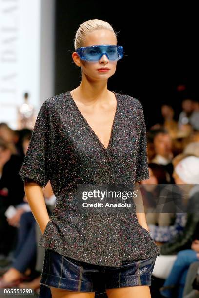 Model presents a creation by Russian designer Julia Dalakian during the Mercedes-Benz Fashion Week in Moscow, Russia on October 23, 2017.