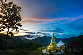Gold pagoda over Salween river on Ban Mae Sam Laep, Sop Moei District, Mae Hong Son province between Thailand and Myanmar border in twilight.