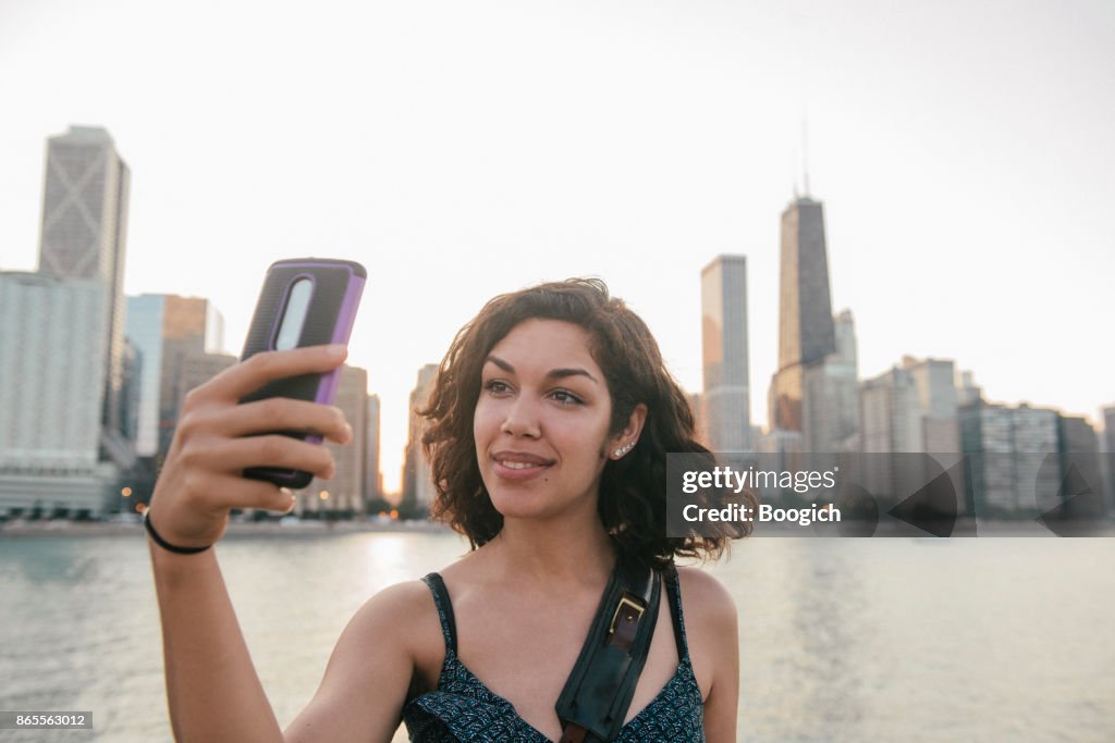 Millennial Hispanic Woman Takes Selfie at Chicago Skyline