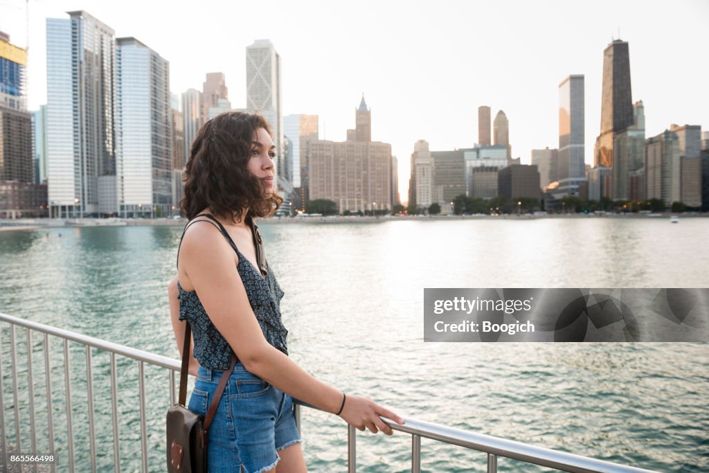 Millennial Hispanic Woman by Chicago Skyline in Contemplation