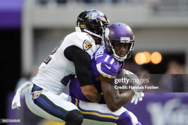 Jimmy Smith of the Baltimore Ravens tackles Laquon Treadwell of the Minnesota Vikings during the game on October 22, 2017 at US Bank Stadium in...