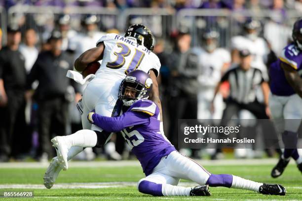 Marcus Sherels of the Minnesota Vikings tackles Bobby Rainey of the Baltimore Ravens on a kick return during the game on October 22, 2017 at US Bank...
