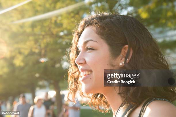 portrait of happy millennial hispanic woman in chicago park - hot puerto rican women stock pictures, royalty-free photos & images