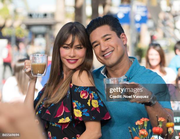 Sofia Vergara and Mario Lopez drink coffee together at "Extra" at Universal Studios Hollywood on October 23, 2017 in Universal City, California.