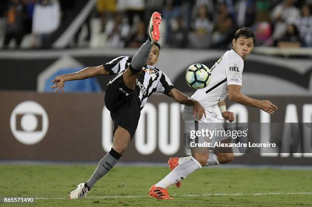Arnaldo of Botafogo battles for the ball with Angel Romero of Corinthians during the match between Botafogo and Corinthians as part of Brasileirao...