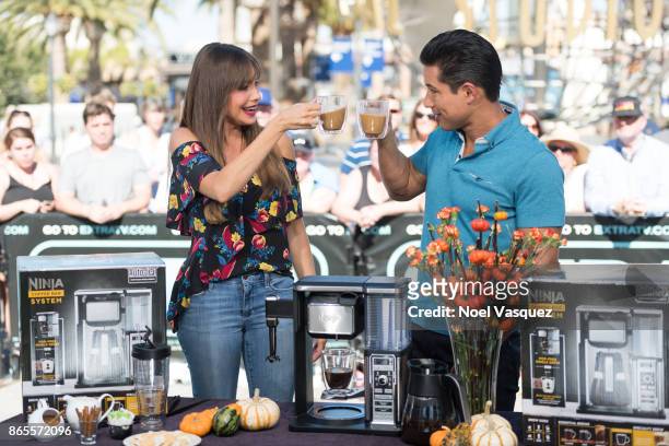 Sofia Vergara and Mario Lopez drink coffee together at "Extra" at Universal Studios Hollywood on October 23, 2017 in Universal City, California.