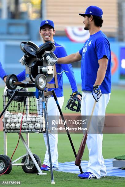 Kenta Maeda and Yu Darvish of the Los Angeles Dodgers talk on the field ahead of the World Series at Dodger Stadium on October 23, 2017 in Los...
