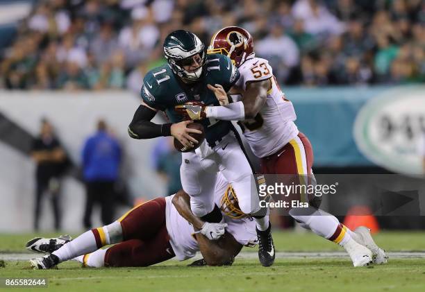 Zach Brown and Mason Foster of the Washington Redskins sack quarterback Carson Wentz of the Philadelphia Eagles during the second quarter of the game...