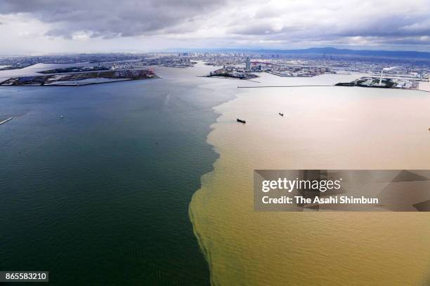 In this aerial image, muddy water flows into Osaka Bay after powerful Typhoon Lan hitting across Japan on October 23, 2017 in Osaka, Japan. Rain...