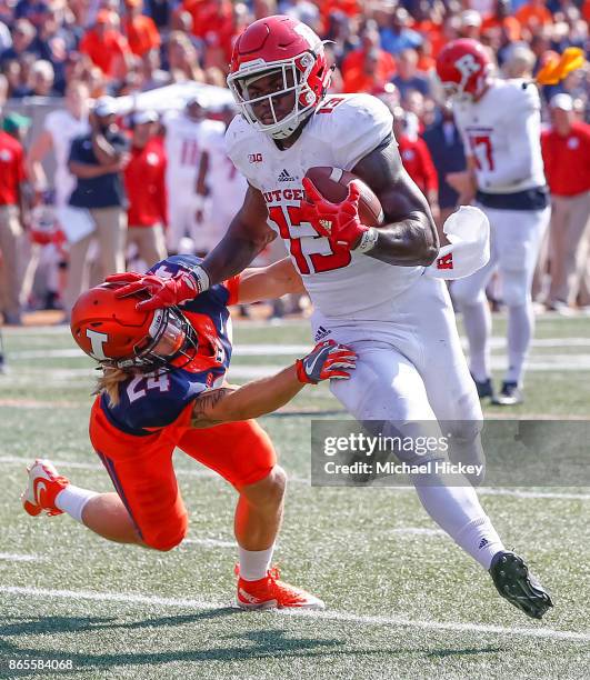 Gus Edwards of the Rutgers Scarlet Knights runs the ball as Dawson DeGroot of the Illinois Fighting Illini attempts the tackle at Memorial Stadium on...
